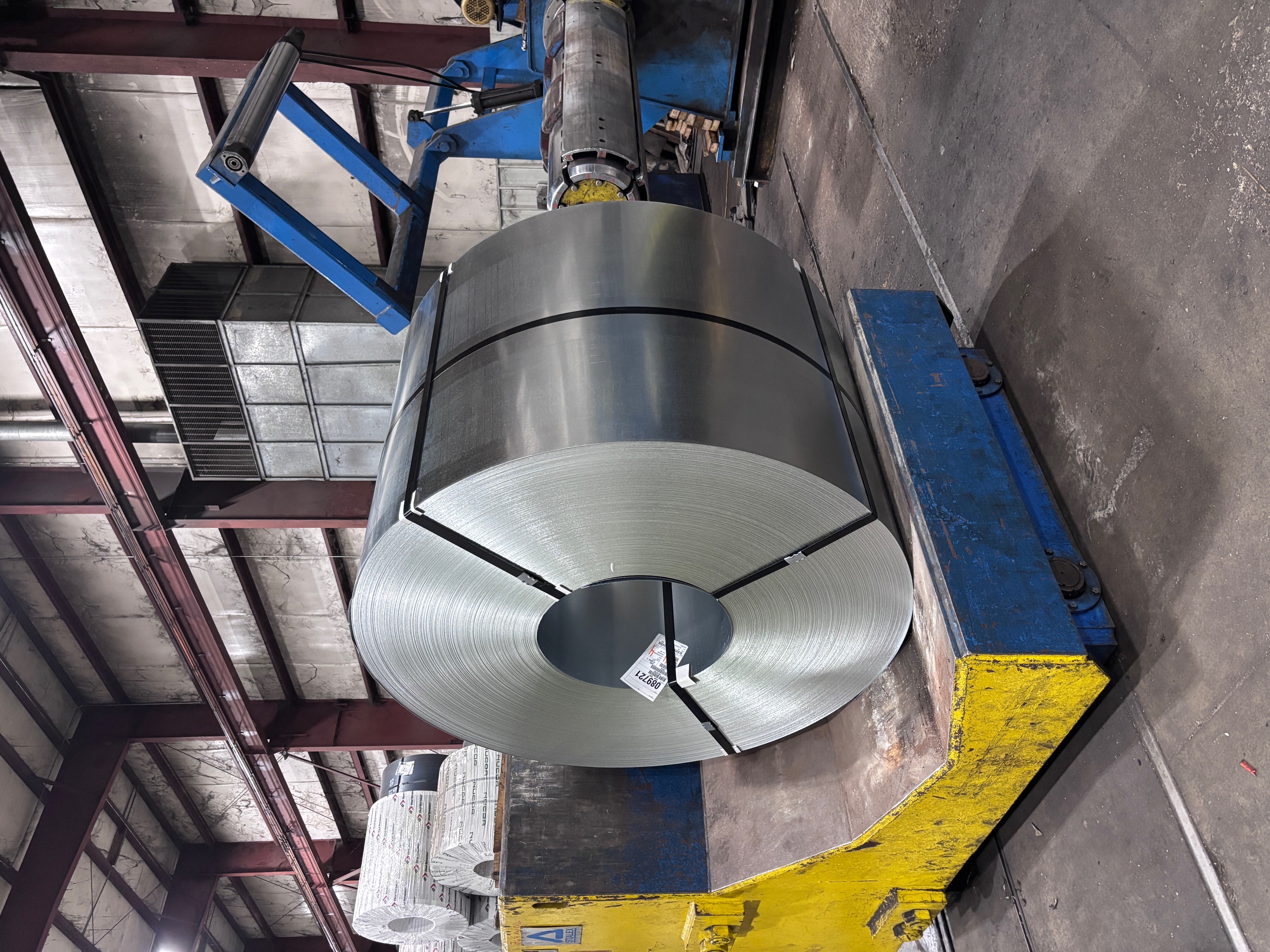 Large master coil staged at the processing cradle inside the facility