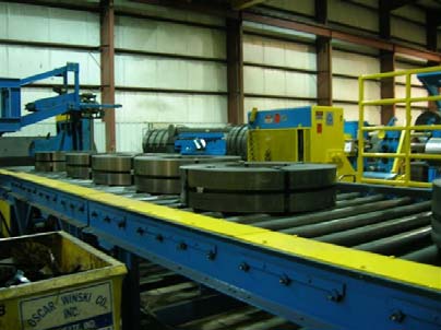 Processed steel coils moving along the Performance Master packaging line